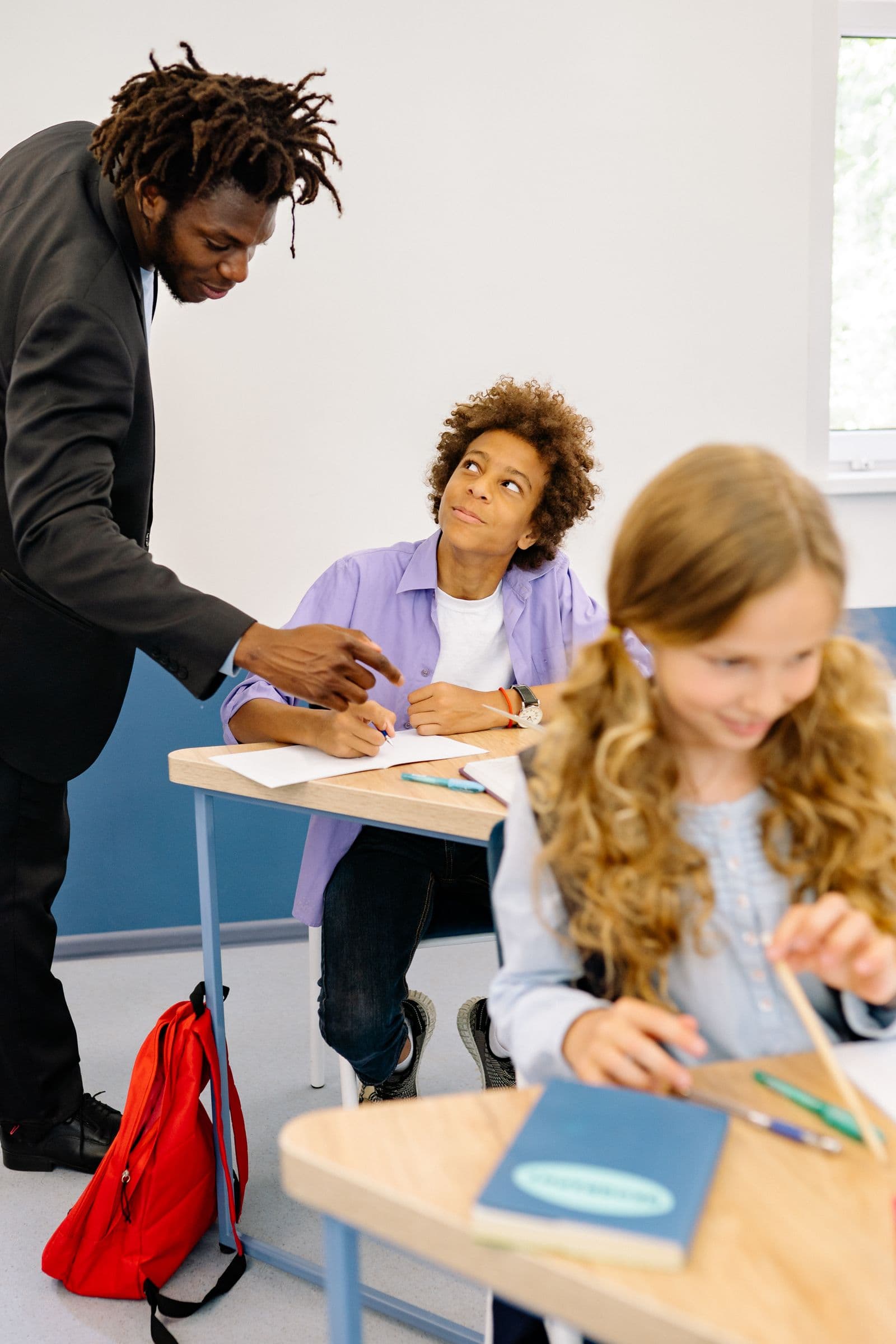 Tutor mentoring a young student during a focused lesson