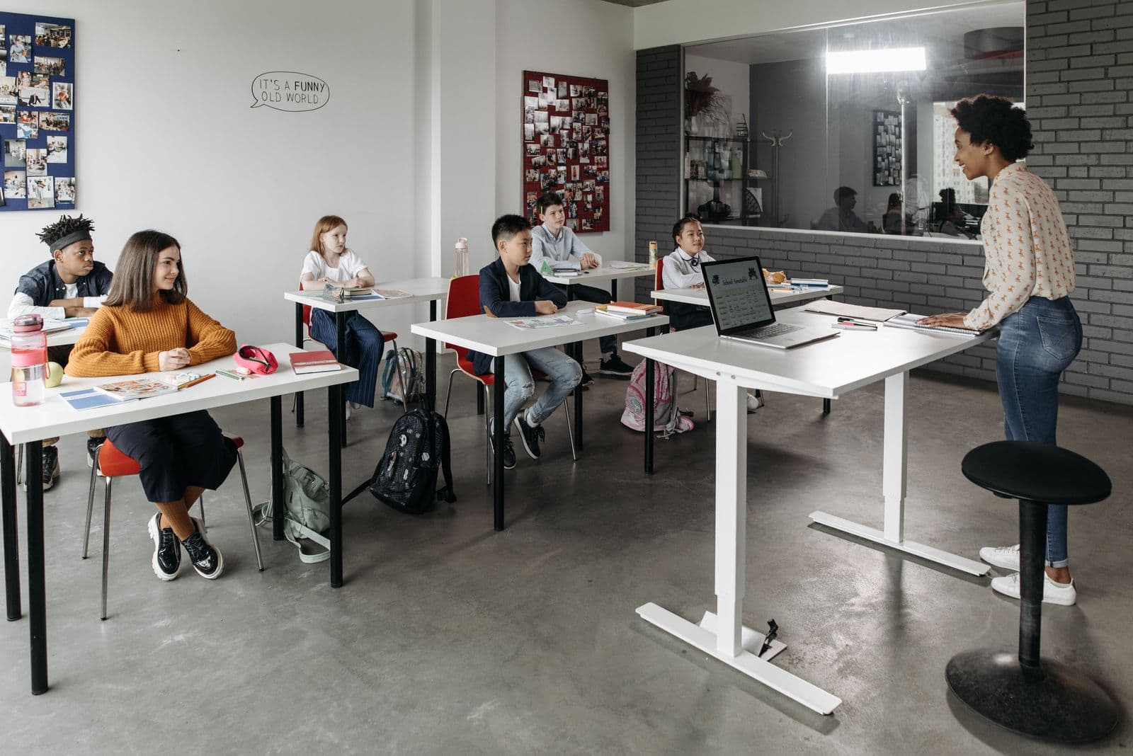 Students seated at desks engaging in a lesson in a bright modern classroom